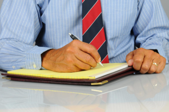businessman using a notepad: Binders Branding and Padholders Article